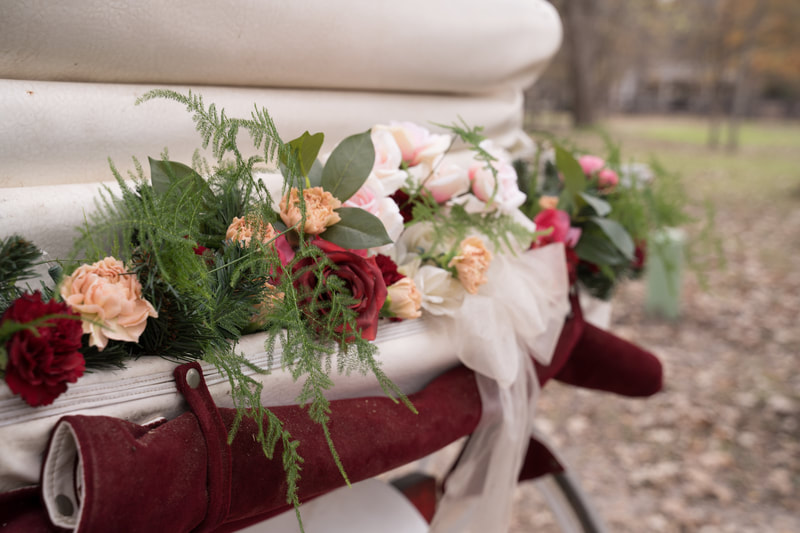burgundy and blush wedding florals on horse carriage