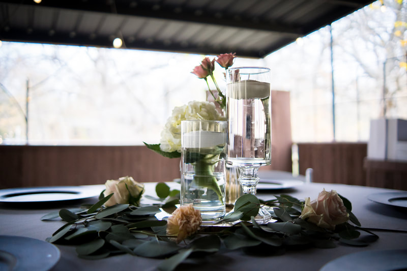 bud vases and floating candles with silver dollar eucalyptus